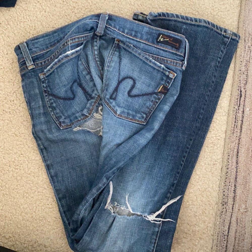 Distressed jean; holes in knee/under butt region